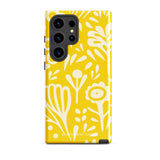 The Sol Dorado for Samsung by Statement Cases is a durable phone case featuring a bright yellow background adorned with an abstract white floral pattern, showcasing various flowers and leaves. Near the bottom edge, the text "STATEMENT CASE" highlights its dual-layer design for enhanced durability.