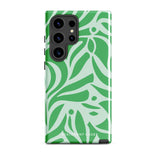 The Selva Verde for Samsung, a product by Statement Cases, is a durable, dual-layer phone case adorned with a green and white leafy design. The back of the case includes a camera cutout, and the bottom is printed with "Statement Cases.