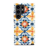 The Mediterranean Bloom for Samsung by Statement Cases features intricate, colorful floral patterns in blue, orange, and yellow. The design covers the entire back of the case, surrounding the camera cutout. Shock-absorbing and impact-resistant, it ensures protection while the brand "Statement Cases" is subtly printed near the bottom.