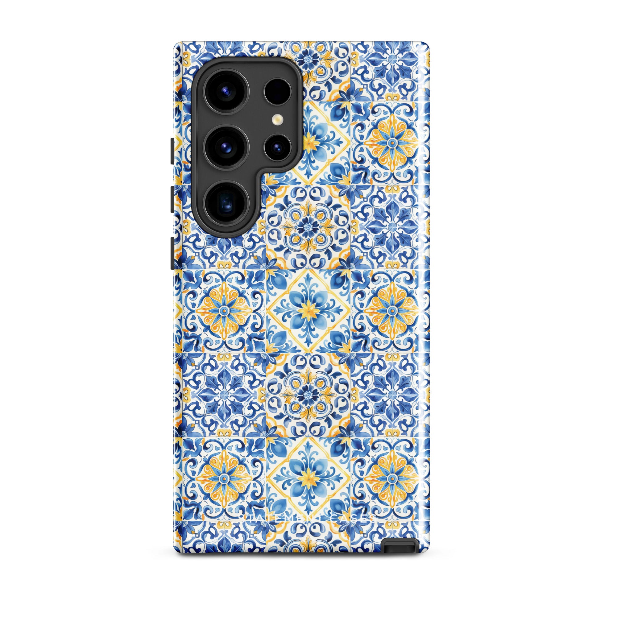 The Blue Mirage for Samsung by Statement Cases is a durable phone case showcasing a detailed blue and yellow tile pattern. The design includes symmetrical floral and geometric motifs reminiscent of classic ceramic tiles. Its impact-resistant dual-layer construction is precisely crafted to fit around the phone's camera and buttons seamlessly.