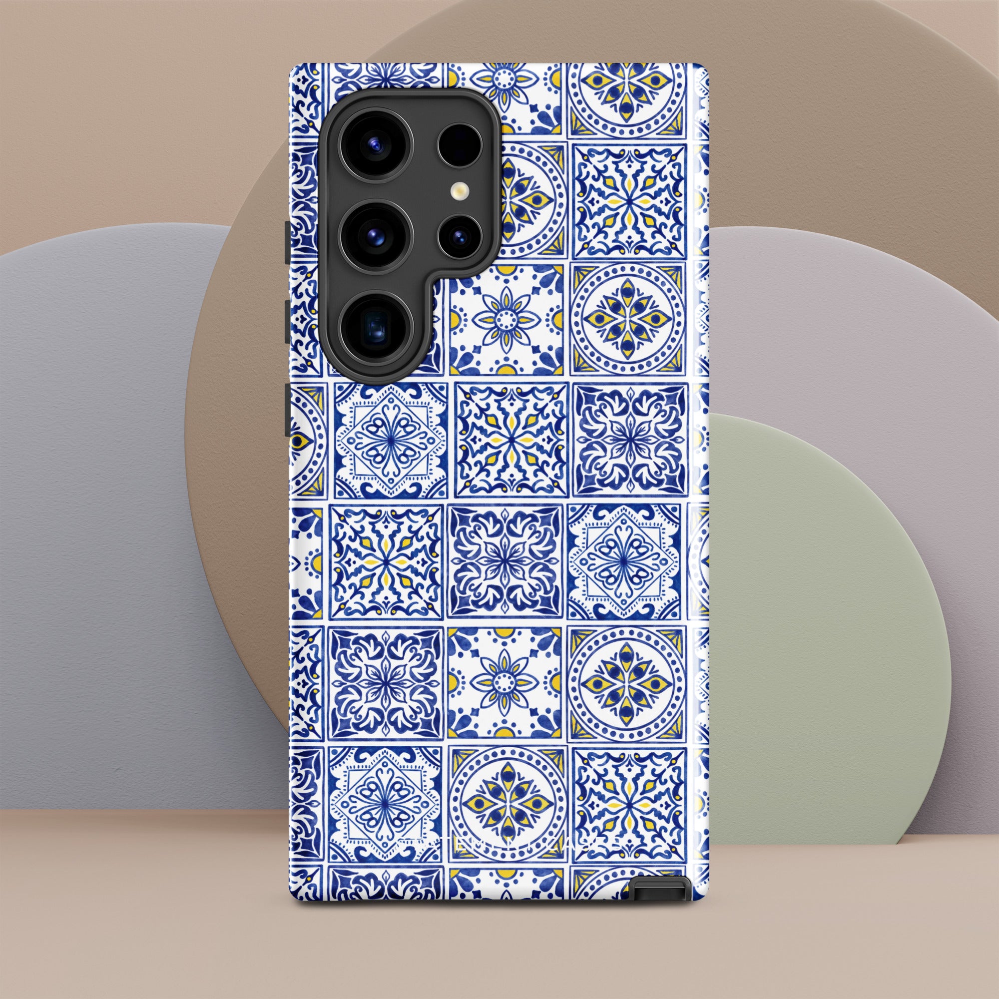 Introducing the Lisboa Azul for Samsung by Statement Cases: A smartphone case adorned with a beautiful blue and white tile pattern. This dual-layer design showcases intricate floral and geometric motifs arranged in a grid that mirrors traditional ceramic tiles. It also features an impact-resistant camera cutout to accommodate multiple lenses seamlessly.