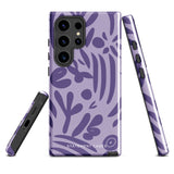 Introducing the Luna Morada for Samsung, a striking smartphone case from Statement Cases. This decorative purple cover boasts abstract floral and organic patterns in darker hues and is designed to absorb shocks. The impact-resistant case features a camera cutout that accommodates five lenses, with the brand name "STATEMENT CASES" elegantly printed at the bottom center.