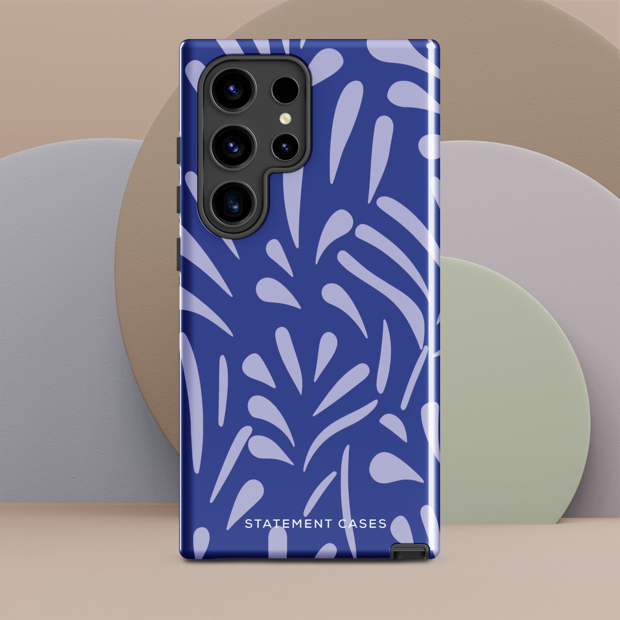 The Mariposa Azul for Samsung smartphone case from Statement Cases is adorned with an impact-resistant design featuring light purple abstract shapes on a blue background. This dual-layer case proudly displays the text "STATEMENT CASES" at the bottom, ensuring that the camera lenses and buttons of your phone remain clearly visible.